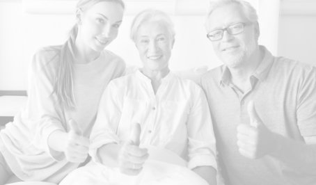 caregiver and couple doing OK sign